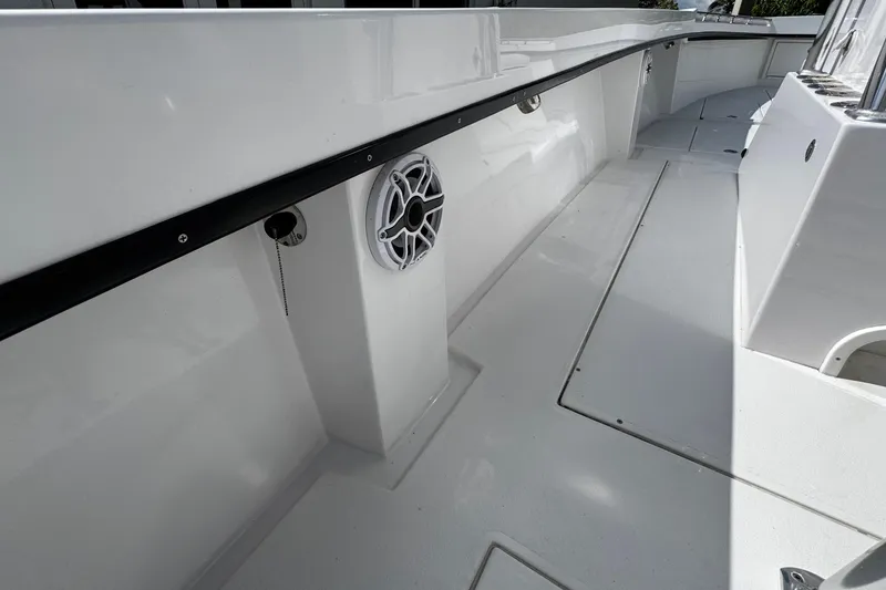 Slide: The Image of 2022 Whitewater 28 Open boat interior with speaker and clean deck design. - 15