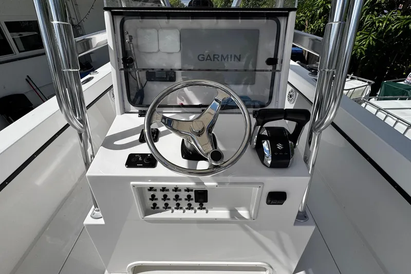 Slide: The Image of 2022 Whitewater 28 Open boat console with Garmin navigation and steering wheel. - 16