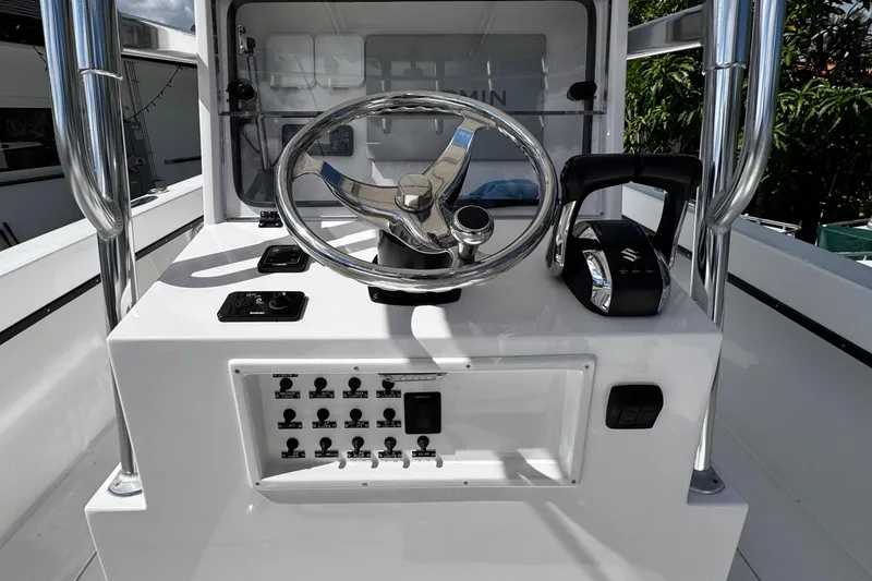 Slide: The Image of 2022 Whitewater 28 Open boat console with steering wheel and controls. - 17