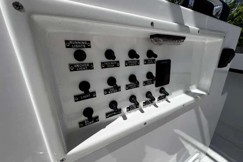 Slide: The Image of Control panel of 2022 Whitewater 28 Open boat with labeled switches. - 18