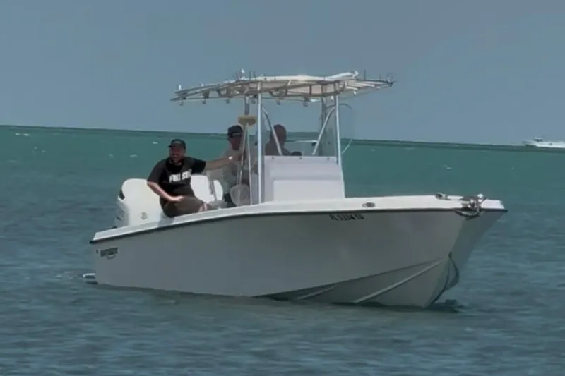 Slide: The Image of 2022 Whitewater 28 Open boat cruising on clear blue water. - 2