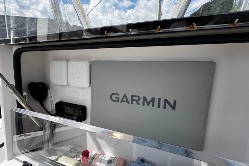 Slide: The Image of 2022 Whitewater 28 Open boat dashboard with Garmin navigation system and Suzuki components. - 21