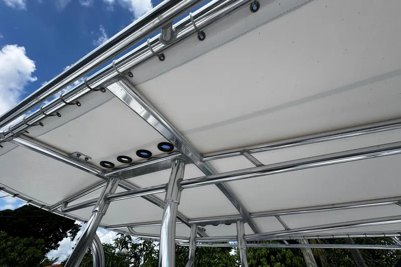 Slide: The Image of 2022 Whitewater 28 Open boat canopy with stainless steel frame under blue sky. - 24