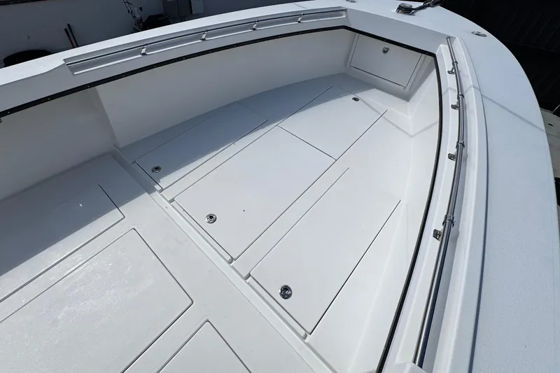 Slide: The Image of 2022 Whitewater 28 Open boat deck with storage compartments and stainless steel railing. - 25