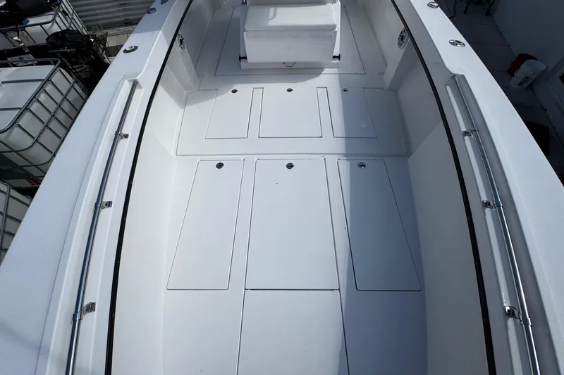 Slide: The Image of 2022 Whitewater 28 Open boat interior with spacious deck and storage compartments. - 27