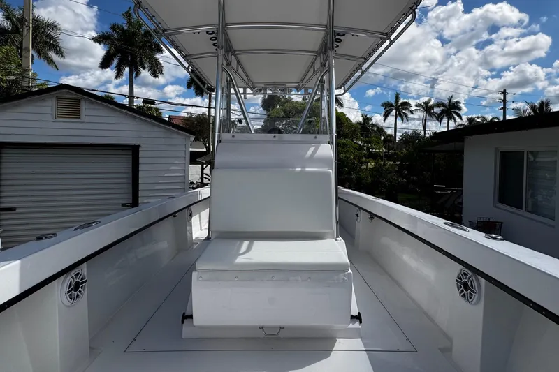 Slide: The Image of 2022 Whitewater 28 Open boat with seating, under a clear blue sky. - 28