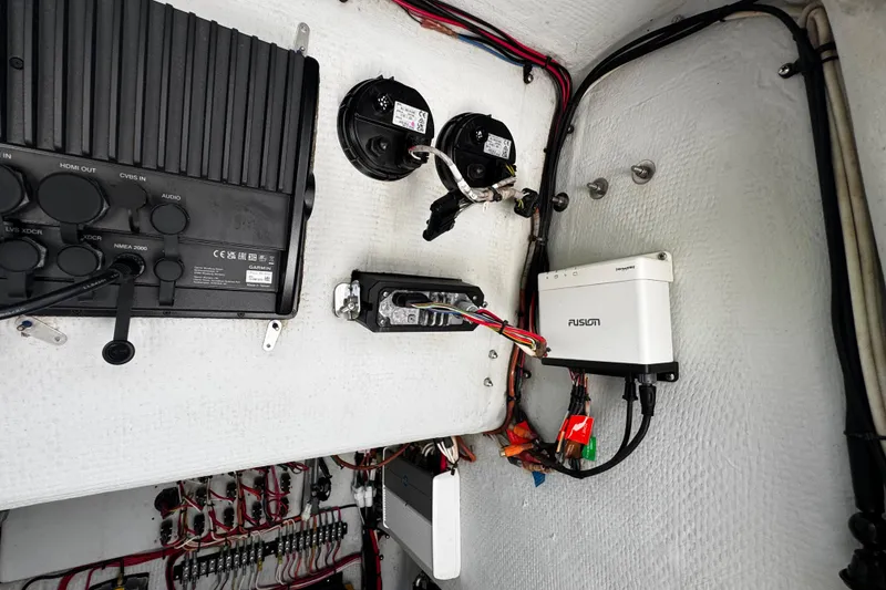 Slide: The Image of Electrical panel inside a 2022 Whitewater 28 Open boat, featuring various electronic components. - 35