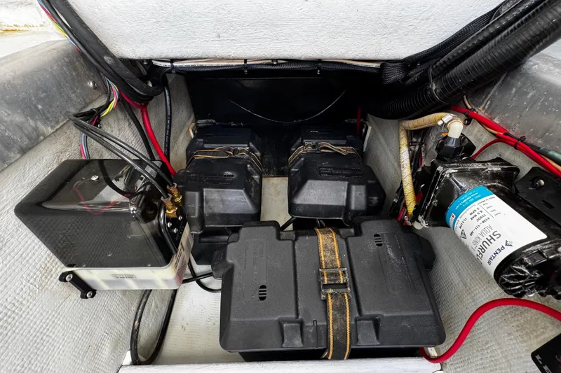 Slide: The Image of 2022 Whitewater 28 Open boat battery compartment with wiring and components. - 37