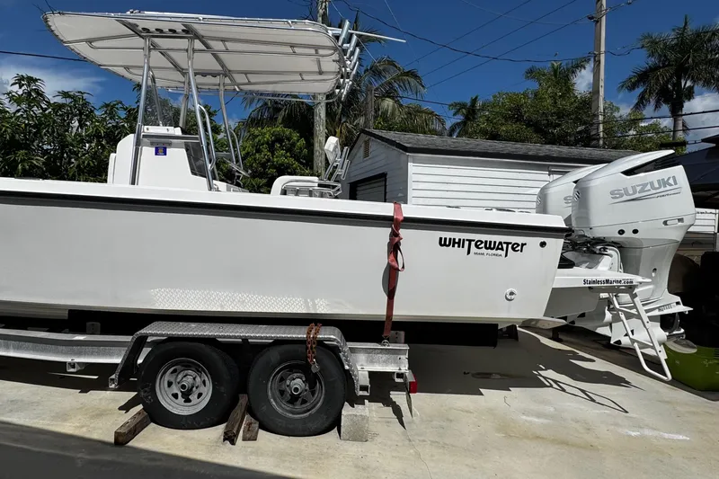 Slide: The Image of 2022 Whitewater 28 Open boat on trailer with Suzuki outboard motor. - 6