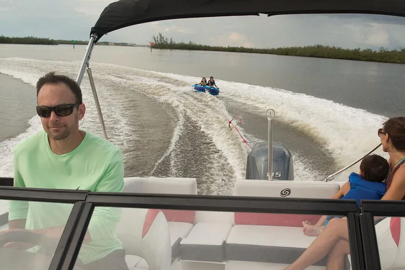 Slide: The Image of Manufacturer Provided Image: 2020 Hurricane SunDeck 191 OB boat towing tubers on a calm lake. - 10