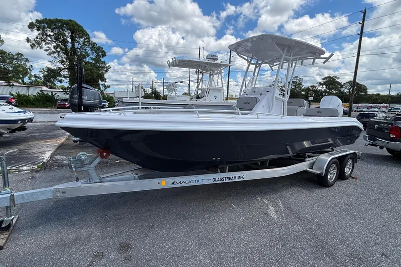 The Image of 2026 Glasstream 240 CCX boat on trailer, parked outdoors under a cloudy sky. - 0