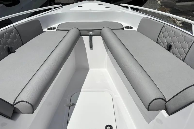 Slide: The Image of 2026 Glasstream 240 CCX boat interior with gray cushioned seating and hexagonal pattern accents. - 13