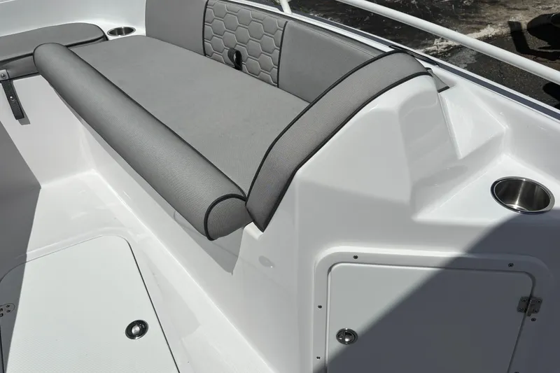 Slide: The Image of 2026 Glasstream 240 CCX boat interior with gray seating and cup holder. - 15