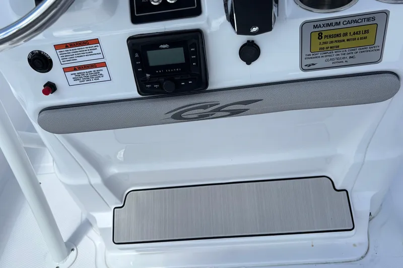 Slide: The Image of Control panel of 2026 Glasstream 240 CCX boat with capacity and warning labels. - 20
