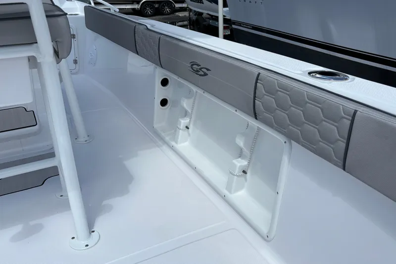 Slide: The Image of 2026 Glasstream 240 CCX boat interior with cushioned seating and storage compartment. - 23