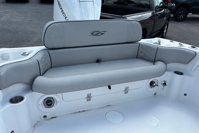 Slide: The Image of 2026 Glasstream 240 CCX boat with gray cushioned seating and storage compartments. - 25