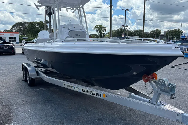 Slide: The Image of 2026 Glasstream 240 CCX boat on trailer in parking lot, under cloudy sky. - 4