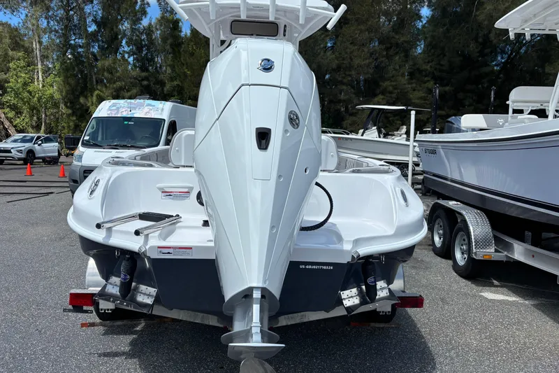 Slide: The Image of 2026 Glasstream 240 CCX boat on trailer, parked outdoors with trees in background. - 5