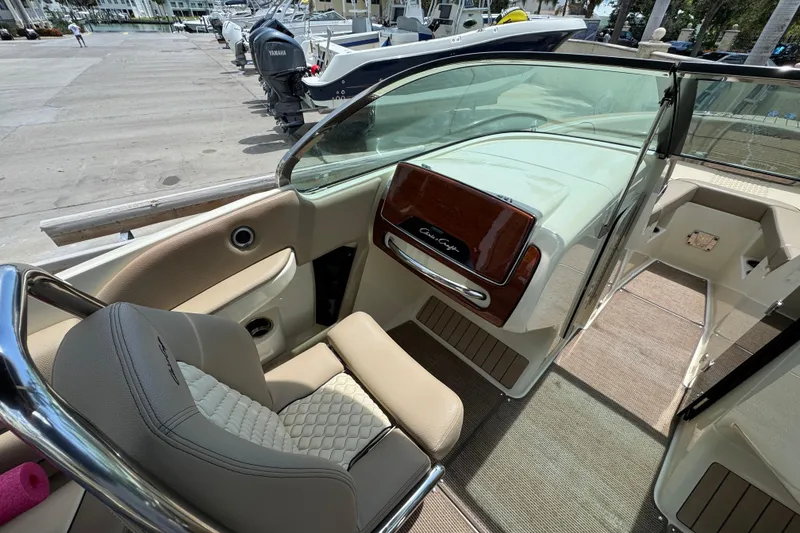 Slide: The Image of 2023 Chris-Craft Launch 25 GT interior with luxurious seating and sleek dashboard design. - 10