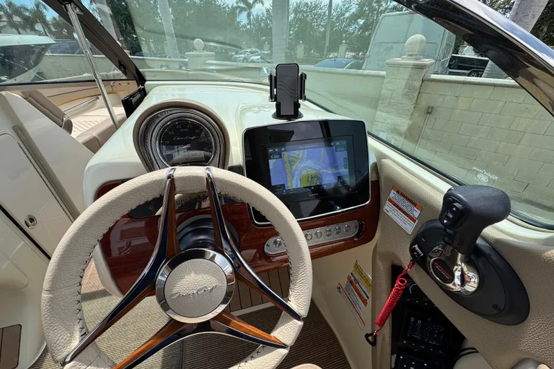 Slide: The Image of 2023 Chris-Craft Launch 25 GT dashboard with steering wheel and navigation display. - 12
