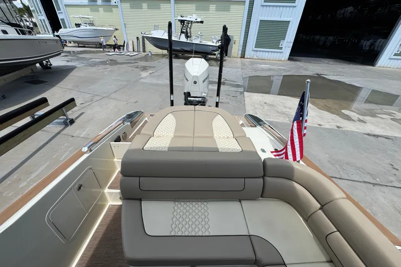 Slide: The Image of 2023 Chris-Craft Launch 25 GT boat with elegant seating and American flag. - 18