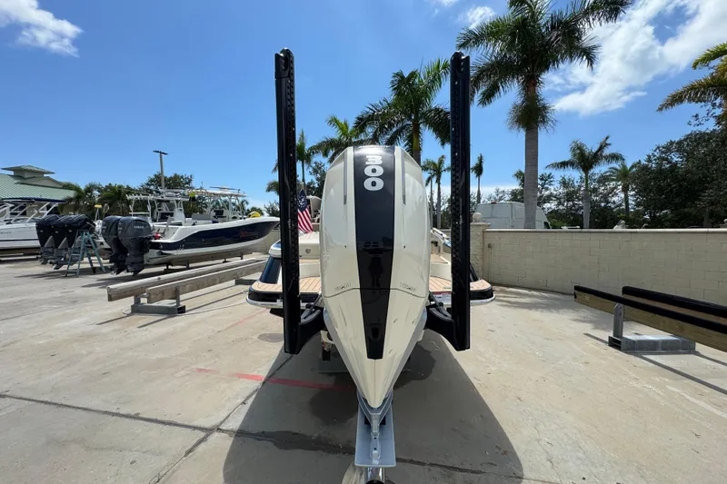Slide: The Image of 2023 Chris-Craft Launch 25 GT boat with powerful engine, docked under clear blue sky. - 22
