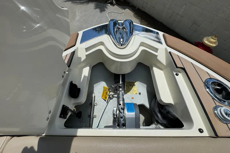 Slide: The Image of 2023 Chris-Craft Launch 25 GT boat anchor compartment with polished chrome details. - 5