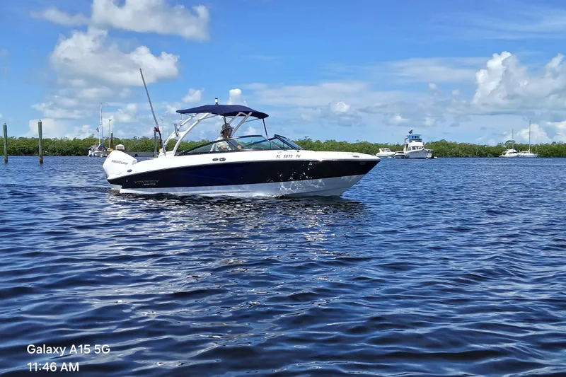 The Image of 2023 Monterey 225 boat cruising on a sunny day with blue skies and calm waters. - 1