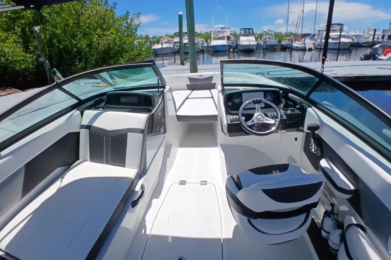Slide: The Image of 2023 Monterey 225 boat interior with sleek design, modern dashboard, and comfortable seating. - 12