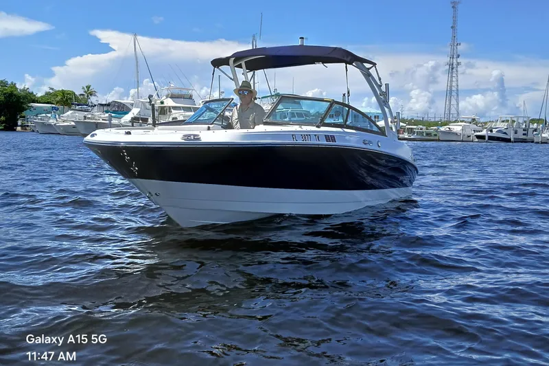 Slide: The Image of 2023 Monterey 225 boat on water, sunny day, marina background. - 2