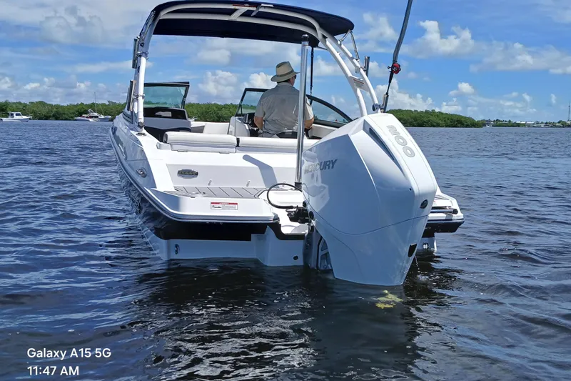 Slide: The Image of 2023 Monterey 225 boat cruising on a sunny day with a Mercury engine. - 5