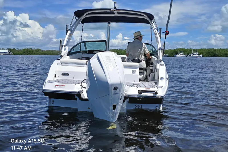 Slide: The Image of 2023 Monterey 225 boat cruising on a sunny day with a person at the helm. - 6