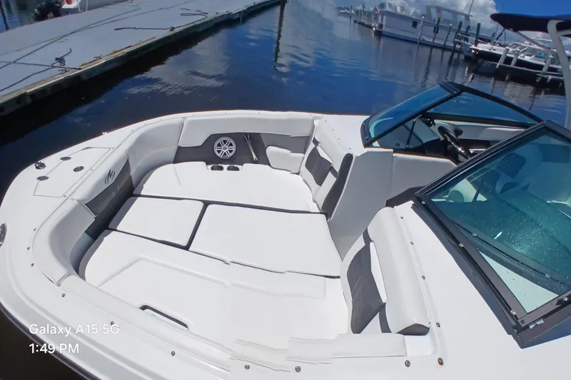 Slide: The Image of 2023 Monterey 225 boat interior with white seating, docked at marina. - 8