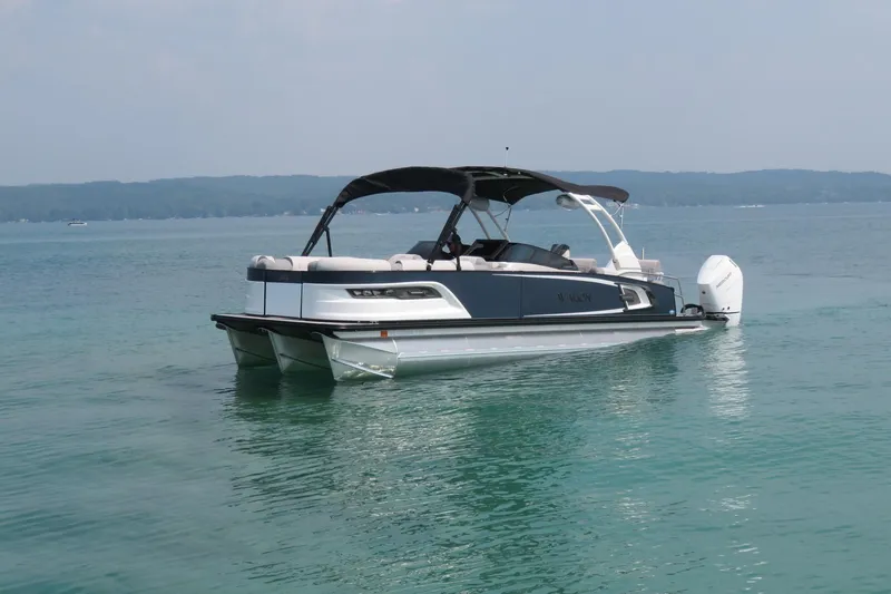 Slide: The Image of 2026 Avalon 2785 Excalibur LTD Quad Lounger Tri-toon on serene Sarasota waters. - 1