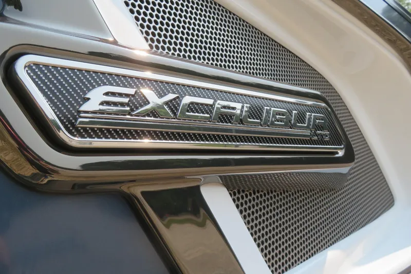 Slide: The Image of Close-up of 2026 Avalon Excalibur LTD emblem on a performance tri-toon boat. - 14
