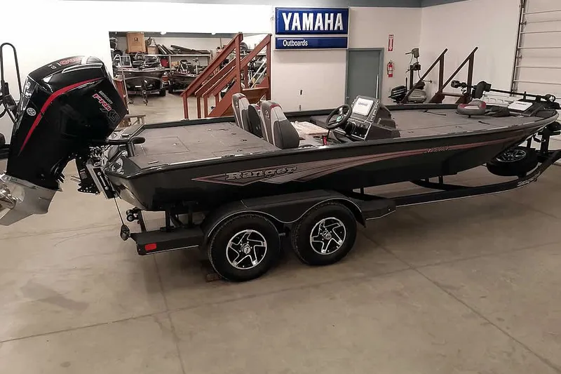 The Image of 2025 Ranger ALPHA 208 boat in showroom, featuring Yamaha outboard motor. - 0