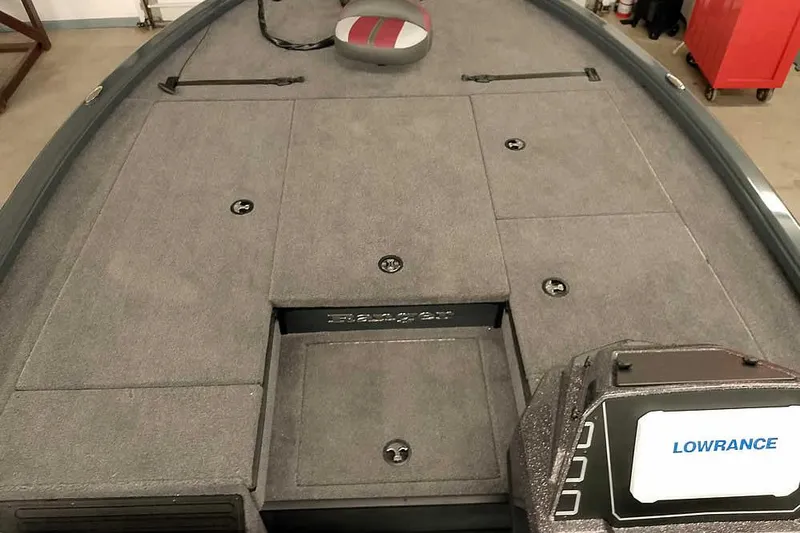 Slide: The Image of 2025 Ranger ALPHA 208 boat deck with Lowrance fishfinder, featuring spacious storage compartments. - 13