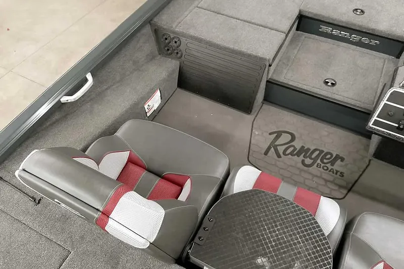 Slide: The Image of 2025 Ranger ALPHA 208 boat interior with gray and red seating, Ranger logo visible. - 24