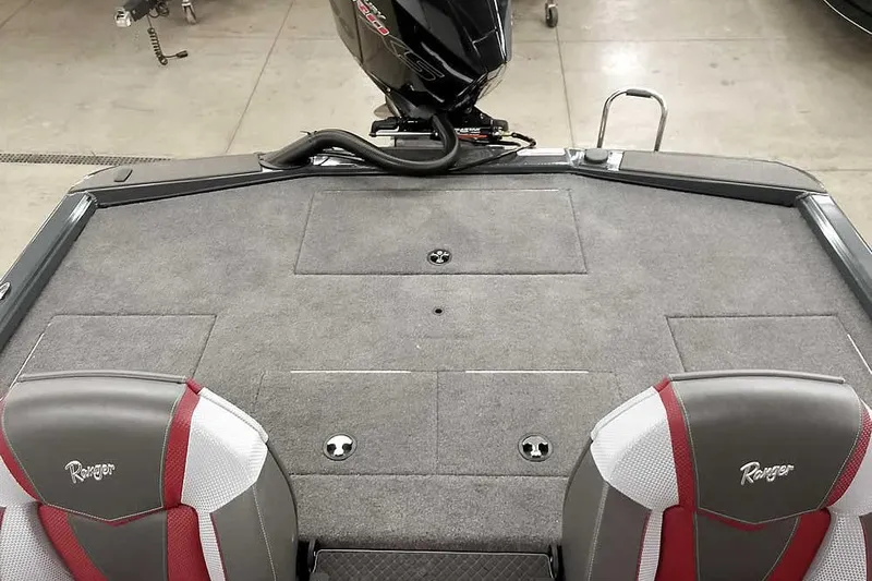 Slide: The Image of 2025 Ranger ALPHA 208 boat interior with gray carpet and dual seats. - 29