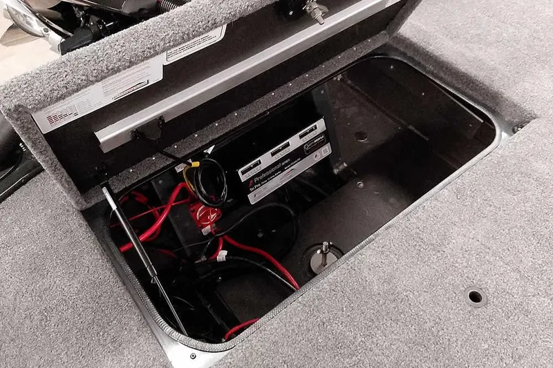 Slide: The Image of Open storage compartment in 2025 Ranger ALPHA 208 boat, showing battery and wiring. - 33
