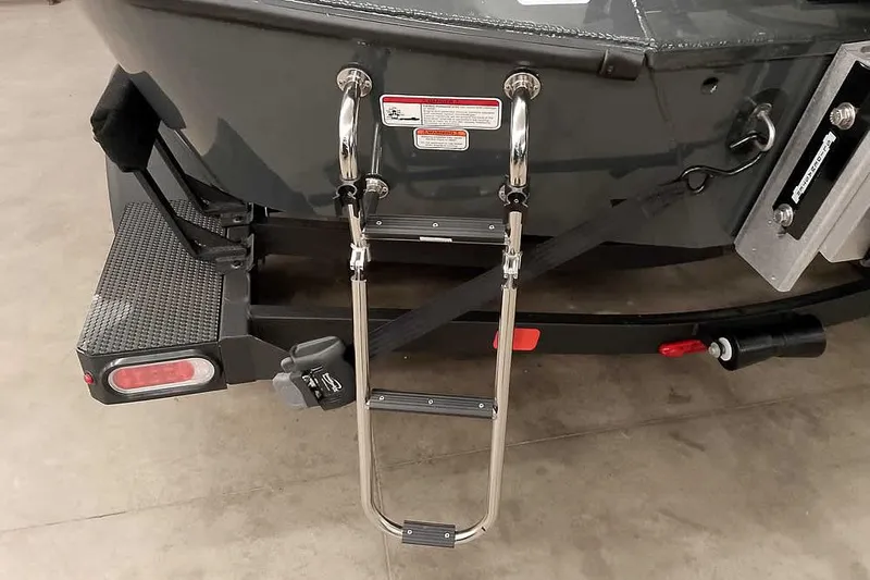 Slide: The Image of Rear view of 2025 Ranger ALPHA 208 boat with ladder and trailer attachment. - 36