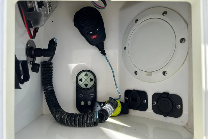 Slide: The Image of 2016 Everglades 243 Center Console boat dashboard with steering wheel and controls. - 11
