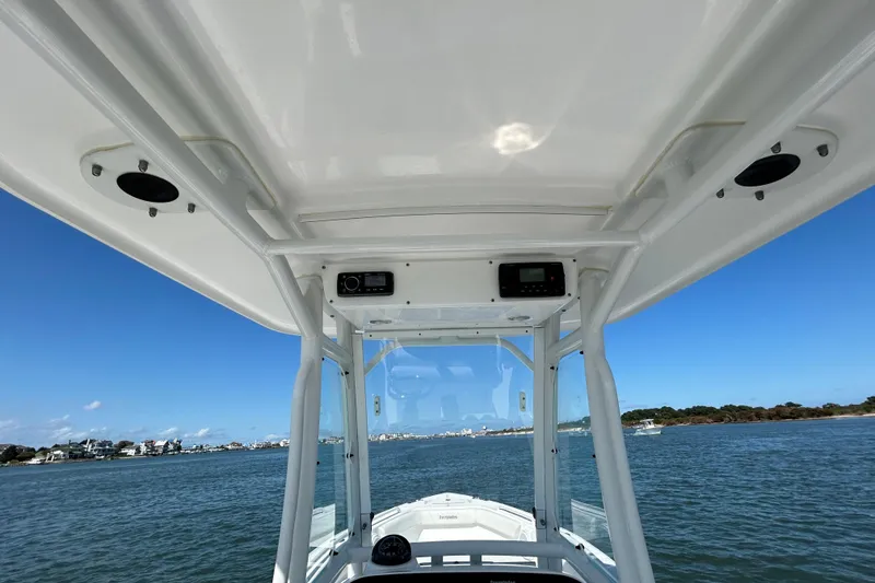 Slide: The Image of 2016 Everglades 243 Center Console boat interior with communication equipment and controls. - 12