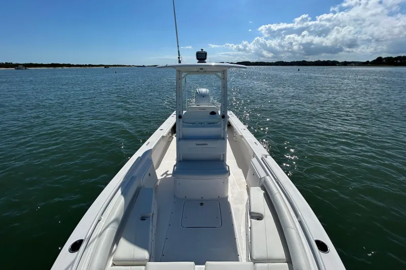 Slide: The Image of 2016 Everglades 243 Center Console boat on calm water, clear sky background. - 14