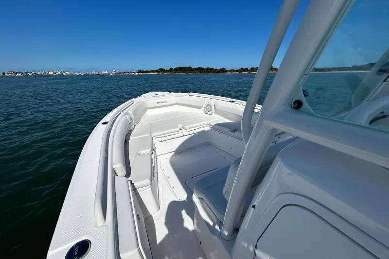 Slide: The Image of 2016 Everglades 243 Center Console boat on calm water under a clear sky. - 15
