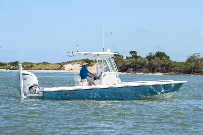 Slide: The Image of 2016 Everglades 243 Center Console boat navigating coastal waters. - 2