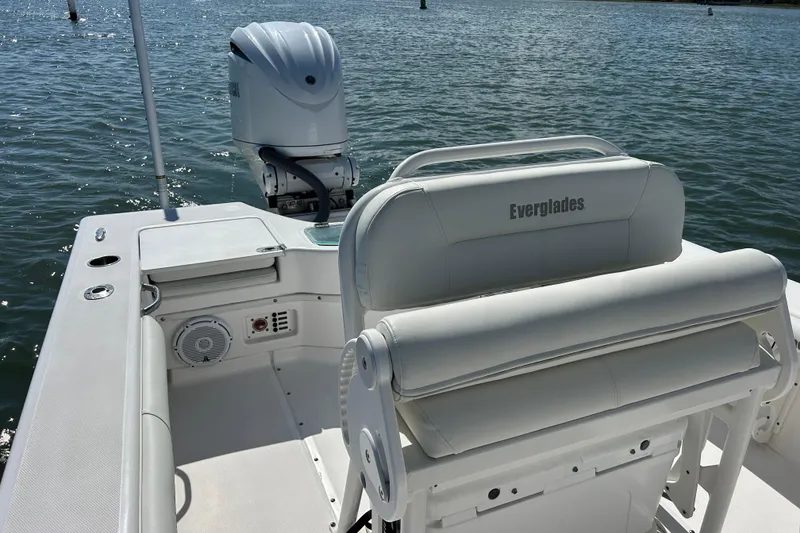 Slide: The Image of 2016 Everglades 243 Center Console boat interior with motor, on calm water. - 5