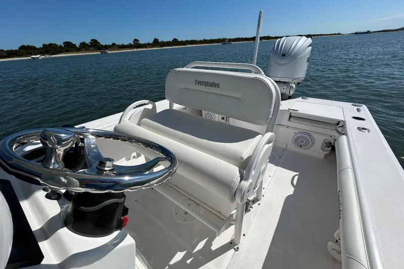 Slide: The Image of 2016 Everglades 243 Center Console boat on calm water, clear sky background. - 7