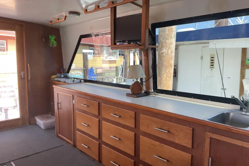 Slide: The Image of Interior of a 1989 Torres 43 boat with wooden cabinetry and large windows. - 10