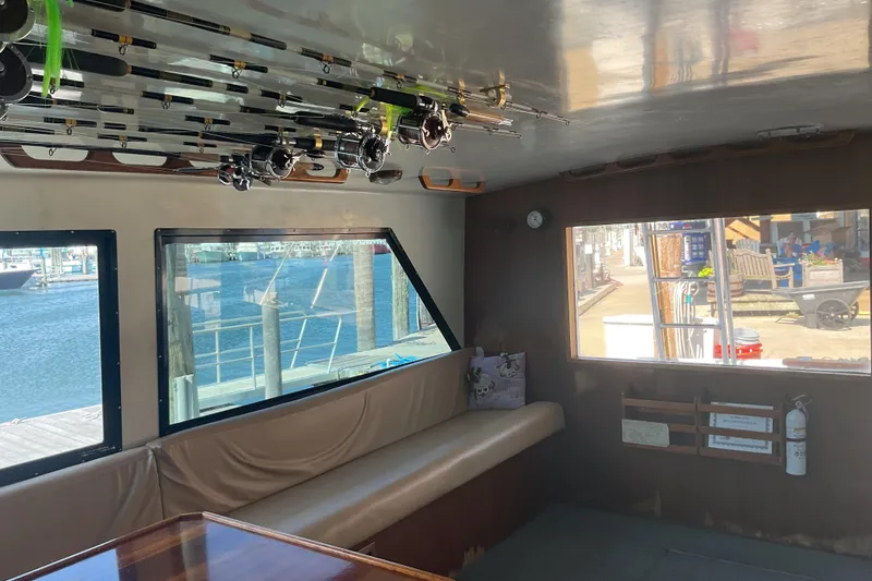 Slide: The Image of Interior of a 1989 Torres 43 boat with fishing rods and waterfront view. - 11